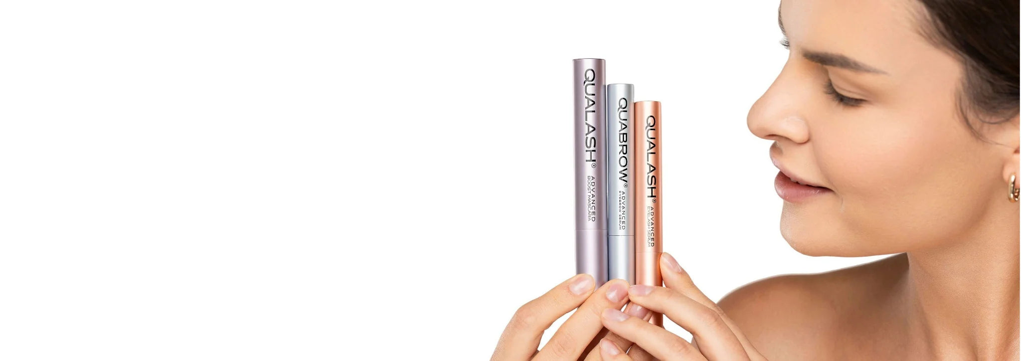 QUALASH advanced mascara and lash serum with QUABROW eyebrow serum held by woman, premium eyelash and eyebrow care