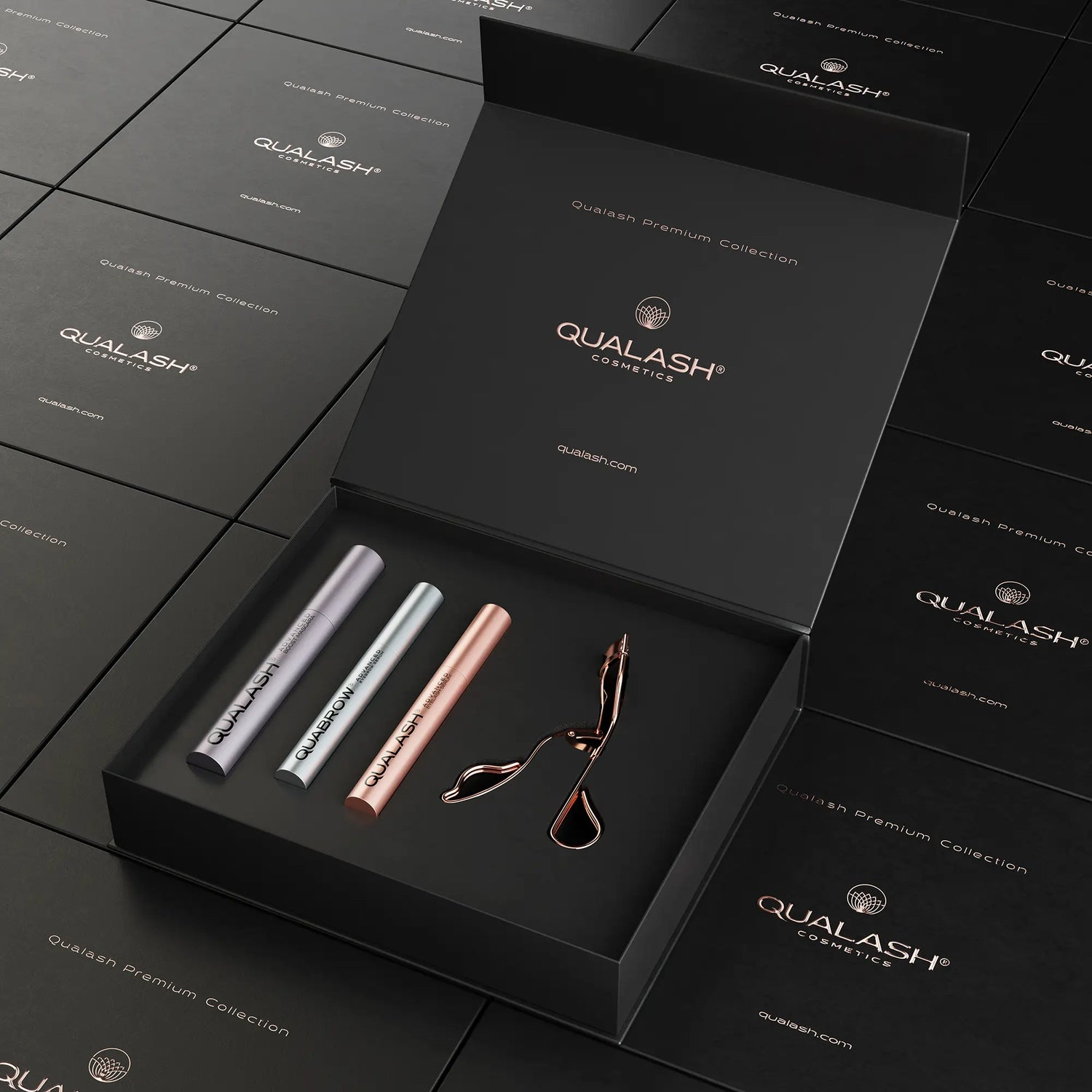 Open Qualash Premium Collection box with eyelash curler and three serums inside